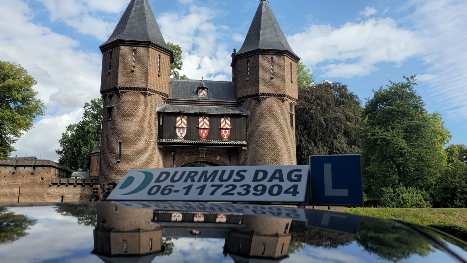 The roof sign of the Durmus Dag lesson car, with De Haar Castle reflected in the roof